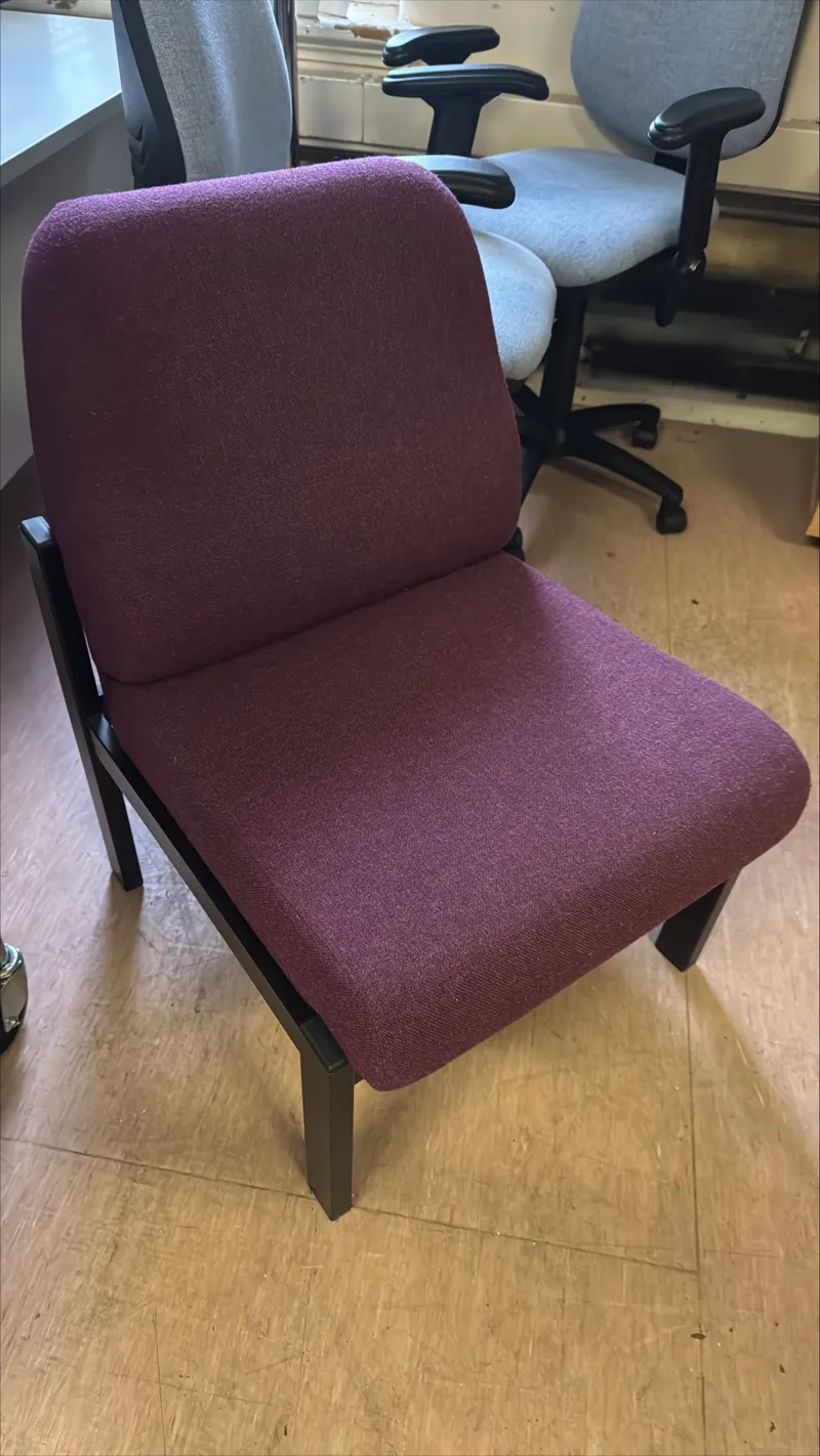 A sturdy office task chair upholstered in burgundy fabric