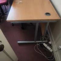 Wooden office desk with metal frame and cable ports