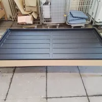 Wooden framed single bed with black plastic mattress frame