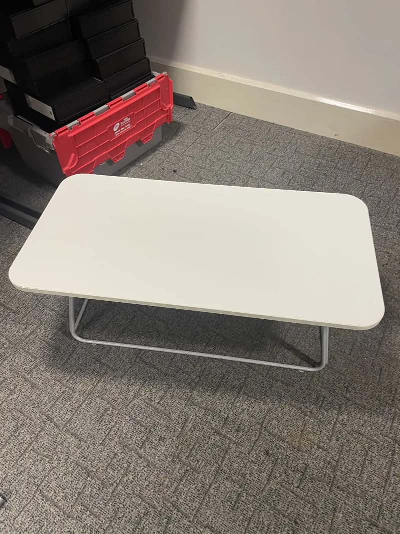 White rounded rectangle coffee table with metal frame legs