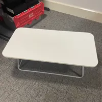 White rounded rectangle coffee table with metal frame legs